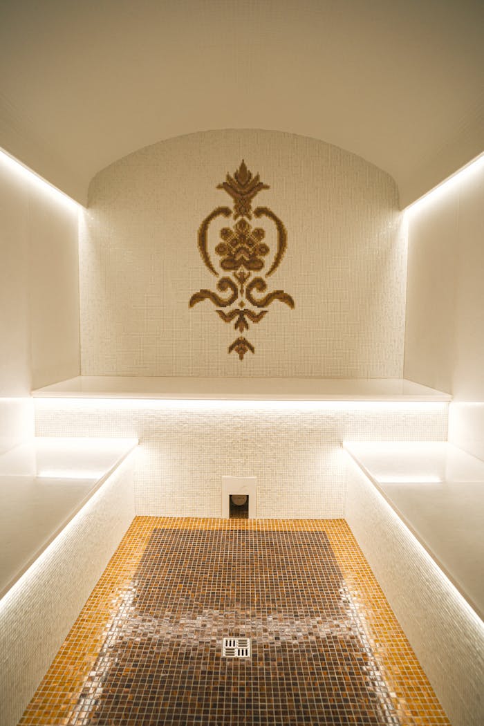our-services-1 Elegant indoor sauna featuring intricate mosaic design and ambient lighting.